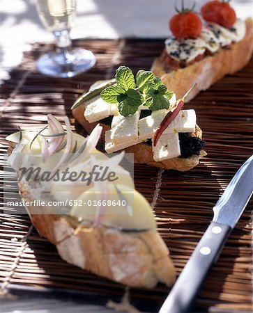 feta with tapenade, mint and peppercorns on bread feta with tapenade, mint and peppercorns on bread