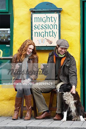 Couple Petting Dog by Pub, Ireland