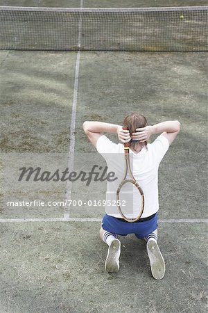 Tennis Player Kneeling on Tennis Court