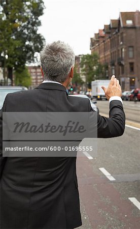 Businessman Hailing Cab, Amsterdam, Netherlands