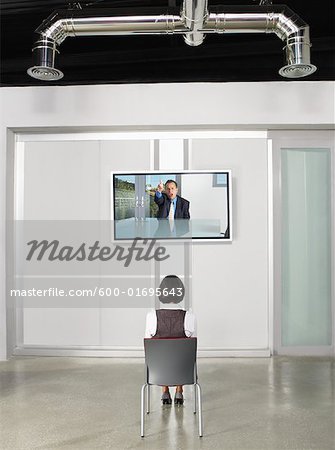Businesswoman Videoconferencing with Big Screen Television