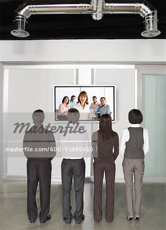 Business People Videoconferencing with Big Screen Television