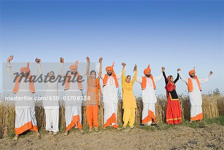 Four young couples standing side by side with holding each others hands