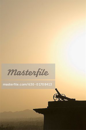 Silhouette of a cannon at sunset, Neemrana Fort, Neemrana, Alwar, Rajasthan, India