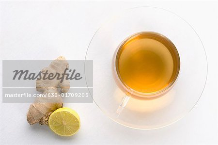 Close-up of a cup of herbal tea with ginger and lemon slice