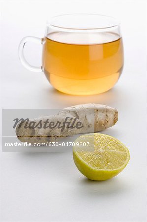 Close-up of a cup of herbal tea with ginger and lemon slice