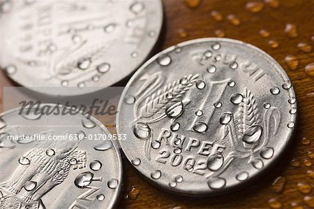 Close-up of water droplets on Indian one rupee coins