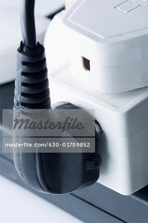 Close-up of electric plugs plugged into an extension socket