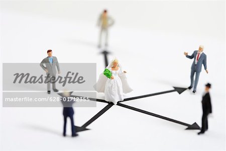 Bride figurine surrounded by businessmen figurines