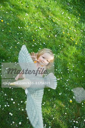 Little girl reaching for fake bird