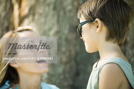 Mother and son, boy wearing sunglasses, woman laughing