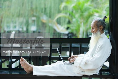 Elderly man in traditional Chinese clothing, barefoot, using laZSop