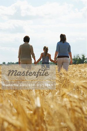 Grandmother, Mother and Daughter Walking in Grain Field