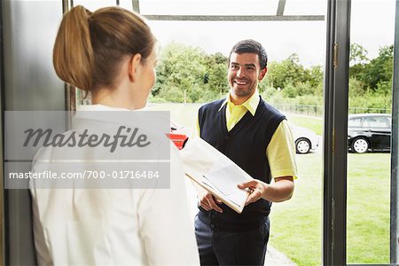 Delivery Person Giving Package to Woman