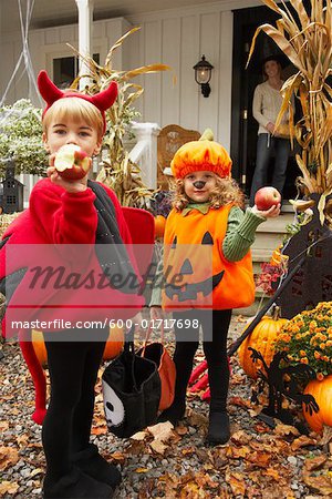 Portrait of Children Eating Apples and Trick or Treating at Halloween