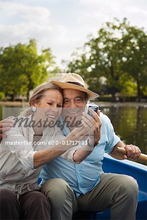 Couple in Rowboat, Taking Photo of Themselves