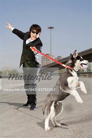 Man holding dog on an overpass