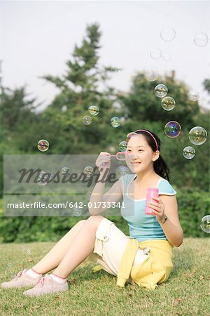 Young woman blowing bubbles