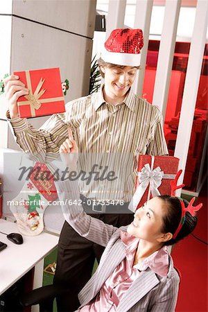 Office woman choosing gift with smile on Christmas Day