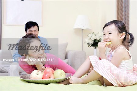 Family sharing fruit at home