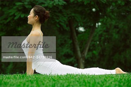 Young woman in white lying on lawn