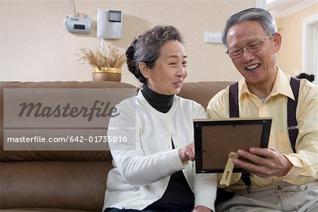 Senior couple looking at photo