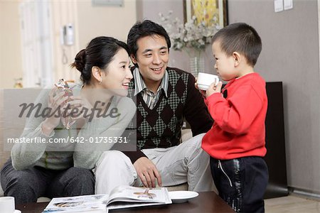 Father and Mother talking with son at home