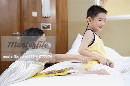 Brother and sister playing in bedroom