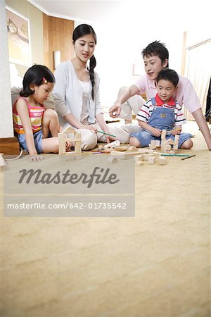 Father and mother playing with children