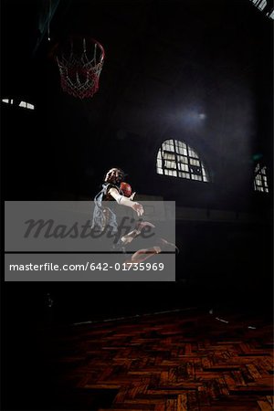 Young man jumping and shooting a basketball
