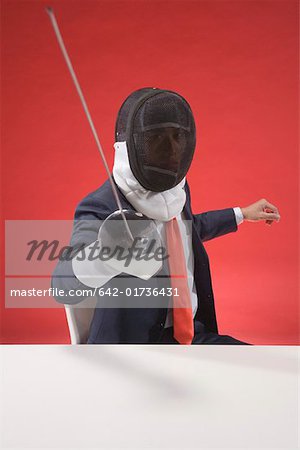 Young businessman with sword