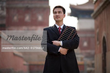 Young man holding abacus