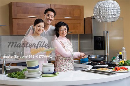 Family washing and cooking in kitchen