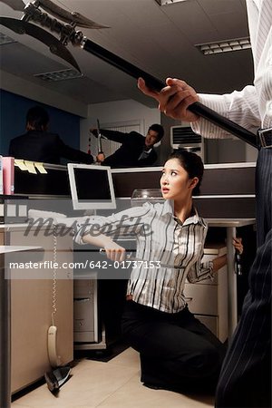 Fighting young men and young woman at office