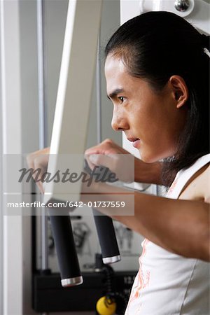 Young man exercising in gym