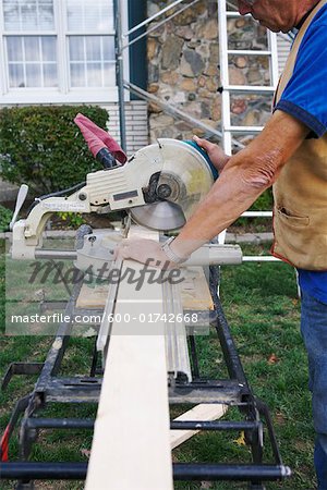 Construction Worker Cutting Wood