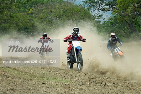 Motocross riders riding motorcycles