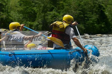 Four people rafting in a river