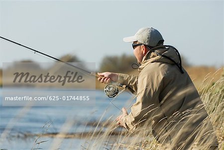 Side profile of a mature man fishing
