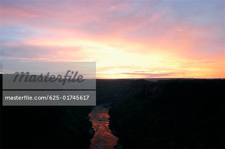 Vue grand angle sur une rivière en passant par les montagnes au coucher du soleil, du Zambèze au Zimbabwe