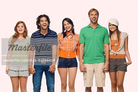 Portrait of two men and three young women standing with holding their hands