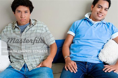 Two young men sitting on a couch