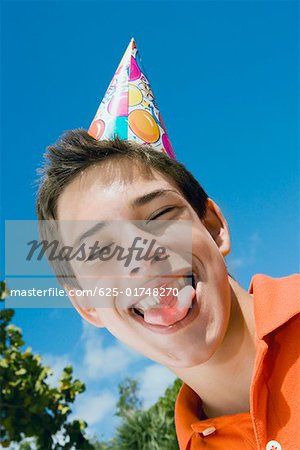 Low angle view of a boy eating a candy