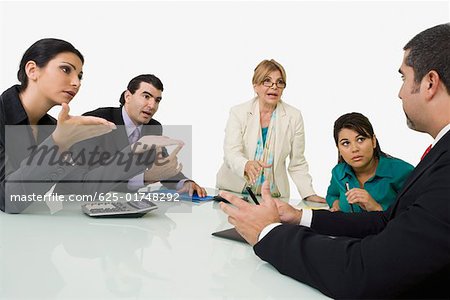 Five business executives discussing in a meeting