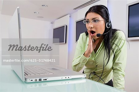 Femme d'affaires à la recherche à un ordinateur portable