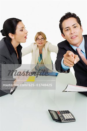 Side profile of a businesswoman shouting at another businessman standing in front of her