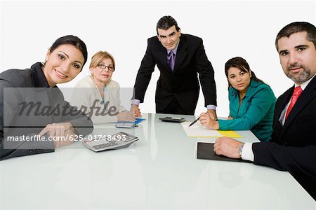 Portrait of two businessmen with three businesswomen in an office