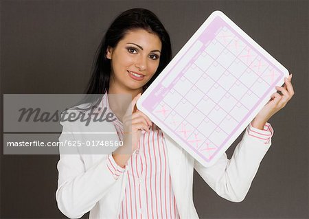 Close-up of a businesswoman holding a calendar