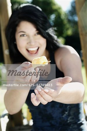 Portrait d'une jeune femme offrant un bonbon de glace