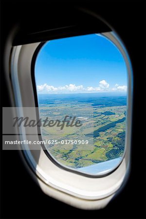 Aerial view of a landscape viewed through an airplane window